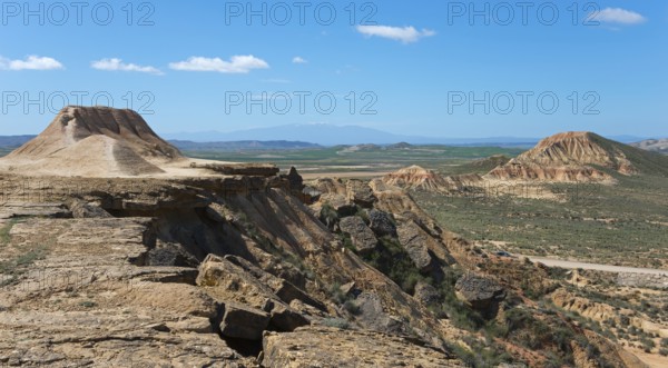 Vast landscape with a plateau and hills under a clear blue sky, Bardenas Reales Natural Park,