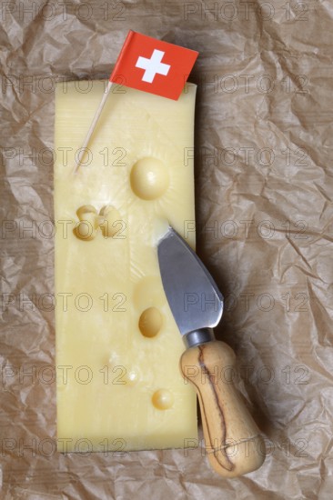 A piece of Swiss Emmental cheese and the Swiss flag