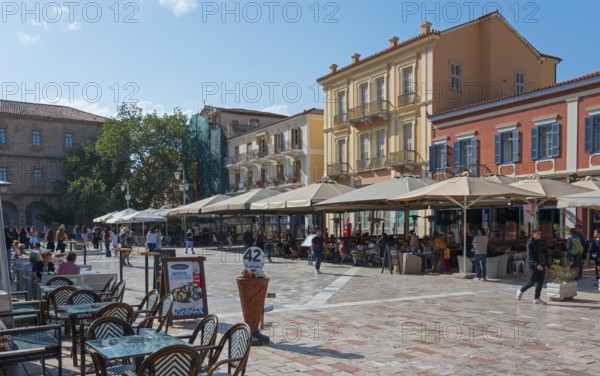 Busy square with cafés and parasols, surrounded by Mediterranean buildings, Syntagma Square,