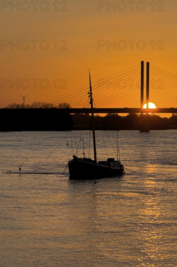 Sunset over river Rhine Lower Rhine, on the left in the foreground anchored historical ship