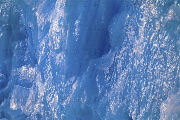 Ice wall in turquoise color with sun reflections on a glacier in arctic, Spitsbergen, Svalbard,