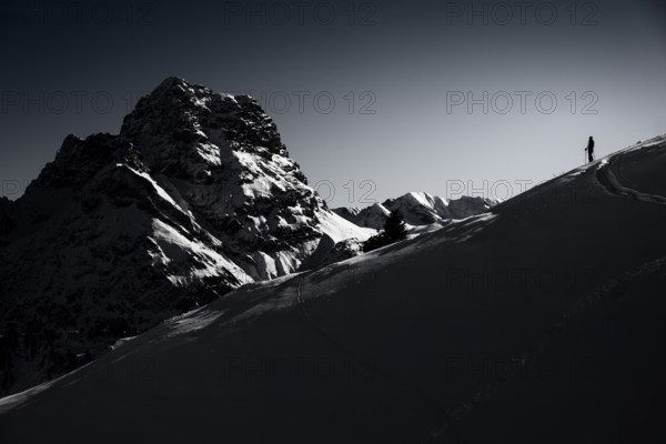 Mountaineers in front of the summit of the Großer Widderstein in winter, Baad, Vorarlberg, Austria,