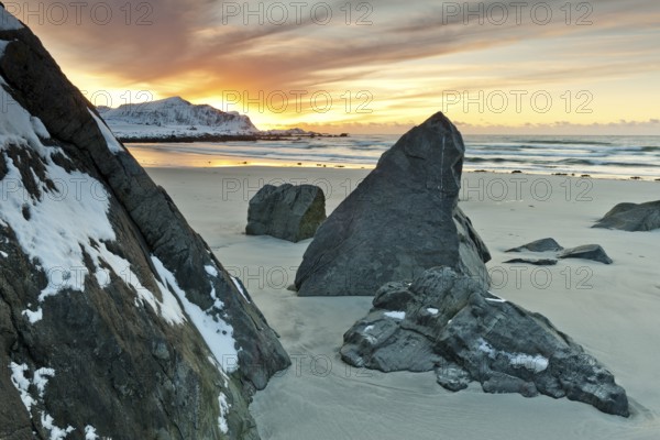 Sunset in winter at Skagsanden, stones on the beach at Flakstad, Flakstadøy, Lofoten, Nordland,