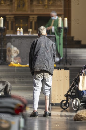A mentally confused homeless man in the church, family mass with blessing of animals in St Agnes,