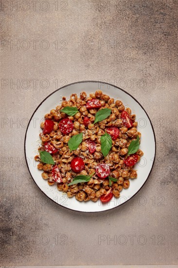 Tuscan pasta with smoked paprika and basil, parmesan cheese, Italian traditional cuisine