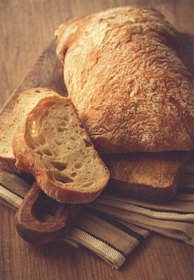 Sliced ciabatta, on a chopping board, italian bread, close-up, Italian cuisine, breakfast, no