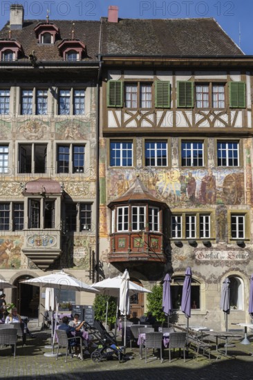 Imposing, historic half-timbered buildings with detailed facade paintings on the market square in