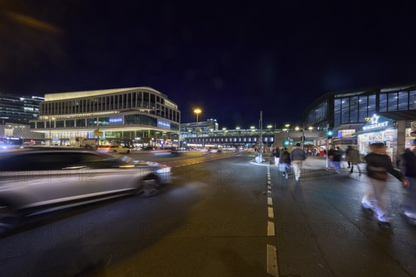 Zoologischer Garten railway station, Primark shop, vehicles and pedestrians with motion blur at