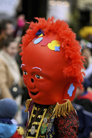 Colourful mask painted with confetti at the carnival parade of the Wey guild on Rose Monday,