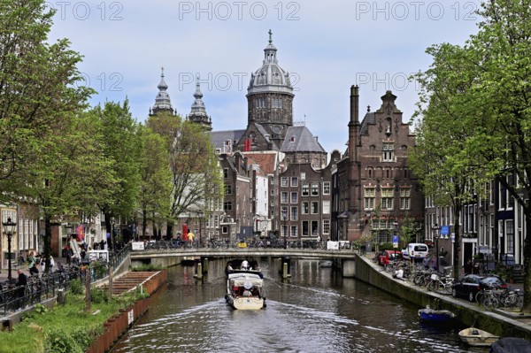 View from a bridge at the Oudezijds Voorburgwal onto the canal and the Sint Nicolaaskerk, St