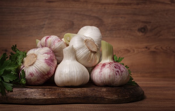 Fresh young garlic, white and purple color, on a wooden table, no people