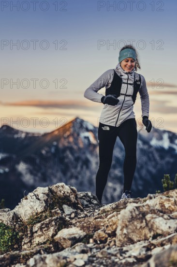 Trail running in autumn on the Jochberg on Lake Walchensee against the wonderful backdrop of the