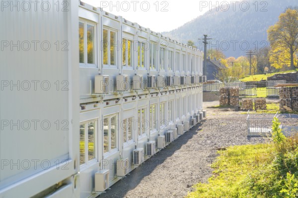 Rows of containers with air coolers in a sunny landscape, Beermiß refugee accommodation centre,