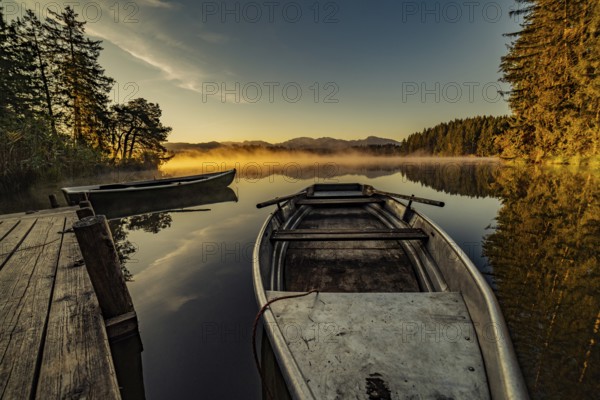 Boats in the autumnal Schmutter Weiher in the Allgäu near the municipalities of Halblech,
