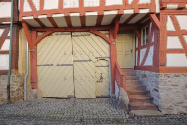 Entrance with gate and stairs to the red half-timbered house, house entrance, red, beams,