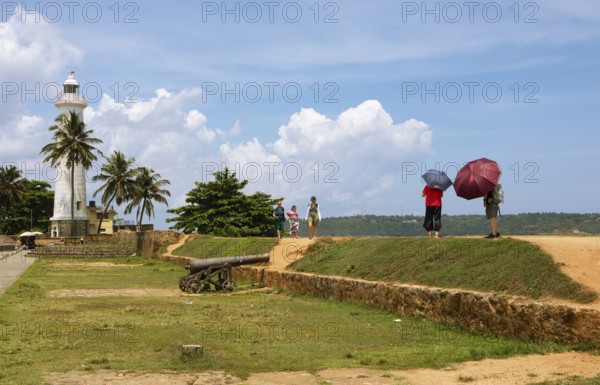Visitors on the causeway to Galle Lighthouse at Dutch Fort, Galle, Southern Province, Sri Lanka,