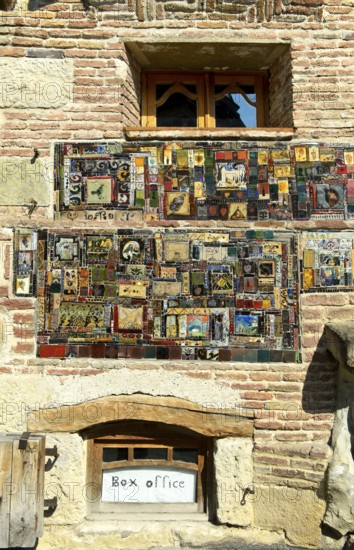 Mosaic of picture tiles on the façade of the historic building of the Rezo Gabriadze puppet