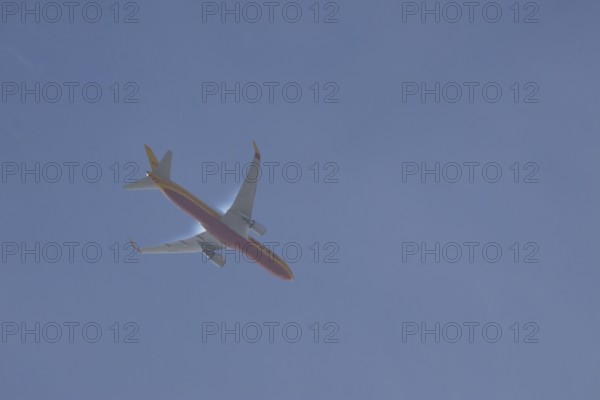 Boeing 767 jet aircraft of DHL airlines flying in a blue sky, England, United Kingdom, Europe