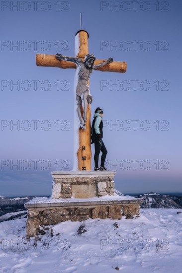 Summit bliss in the snow-covered winter landscape in the Tannheimer Tal in the Alps on the
