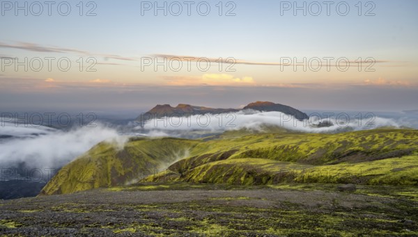 Fog between mountains, moss-covered volcanic mountain landscape, at sunset, Pakgil, Iceland, Europe