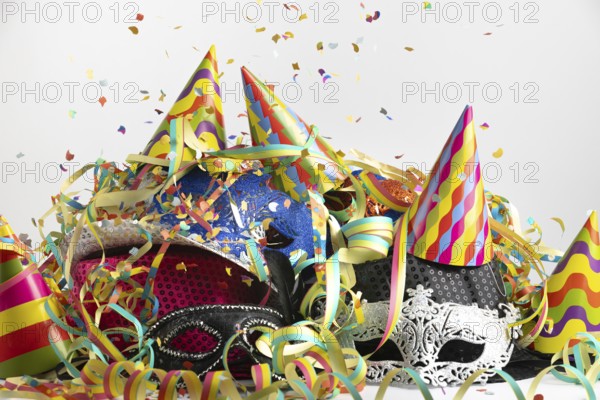 Colourful party hats with confetti and streamers in a lively party setting, carnival