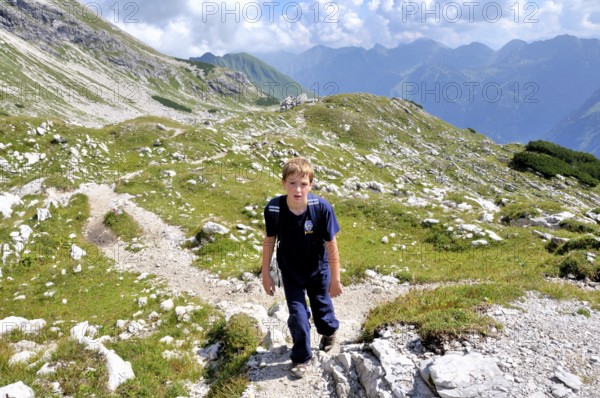 Ten-year-old boy hiking, Nebelhorn, Allgäu Alps, Bavaria, Germany, Europe