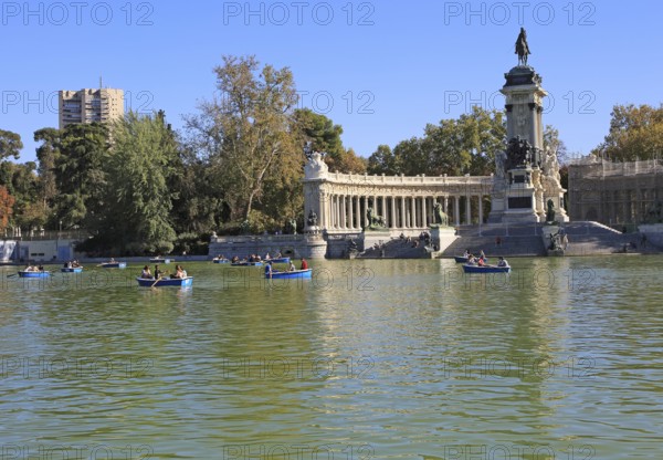 Rowing boats in boating pond of Estanque, El Retiro park, Madrid, Spain, monument to King Alfonso