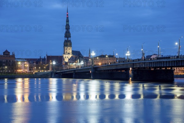 St Peter's Church and stone bridge in the morning at the blue hour, River Daugava, Riga, Latvia,