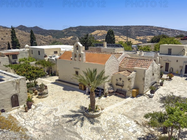 View of courtyard courtyard with Phoenix theophrasti of Odigitria Monastery in the centre