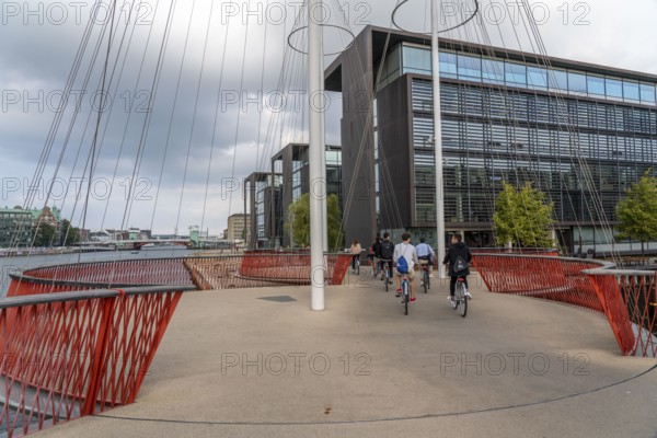 Cyclists on the Cirkelbroen cycle and pedestrian bridge, over the harbour, in the Christianshavens