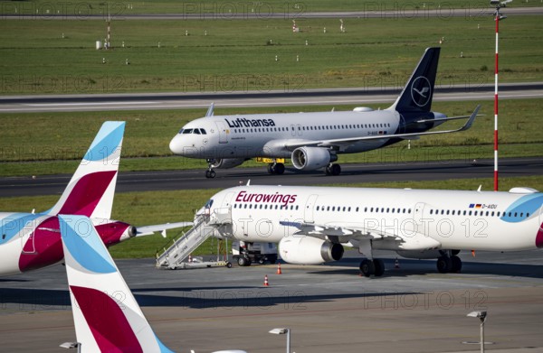 Düsseldorf Airport, Lufthansa Airbus A320-200 on the taxiway, Eurowings Airbus A319-100 in parking