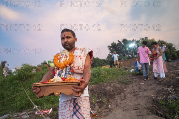 Devotees carries the Ganesha idol to immerse in the Brahmaputra river, during Ganesh Chaturthi