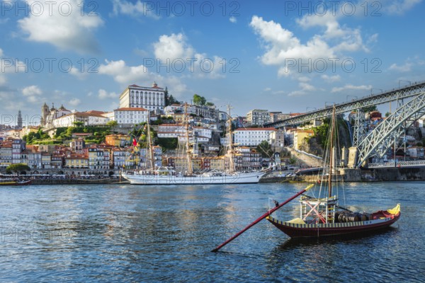 View of Porto city and Douro river with traditional boats with port wine barrels and sailing ship
