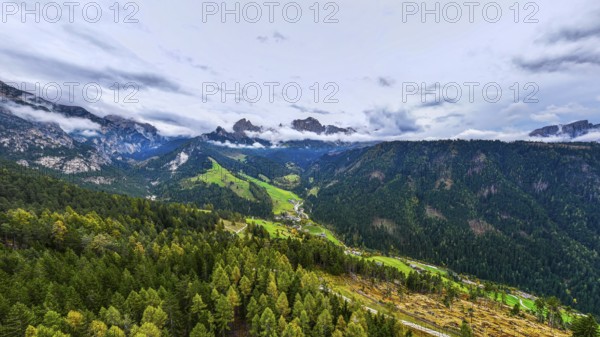 The peaks of the rose garden, shrouded in mist, drone shot, Dolomites, Autonomous Province of