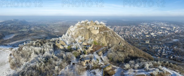 Aerial panorama of the snow-covered Hegau volcano Hohentwiel with Germany's largest castle ruins,