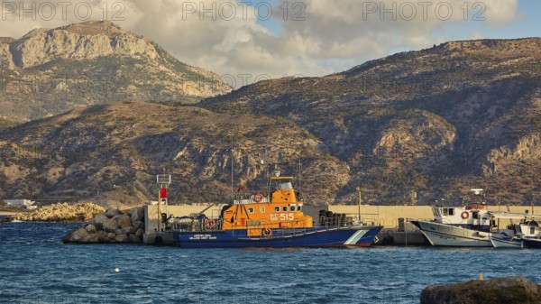 Harbour with fishing boats in front of a mountainous coast, Pigadia, town and harbour, coast guard