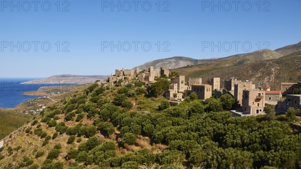 Historic village on a mountain near the coast with clear skies, Vathia, residential tower village,