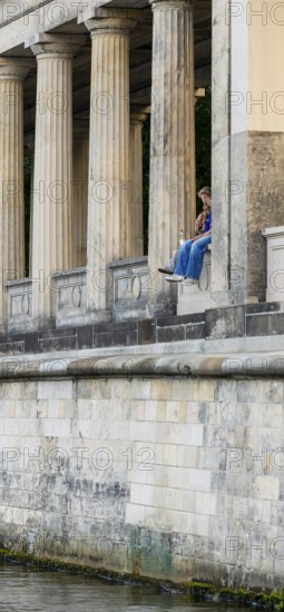 Young couple among the columns of the Neues Museum, Berlin, Germany, Europe