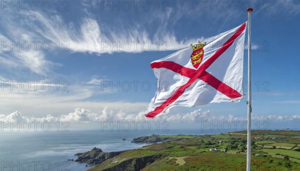 The flag of the Isle of Jersey, Great Britain flutters in the wind