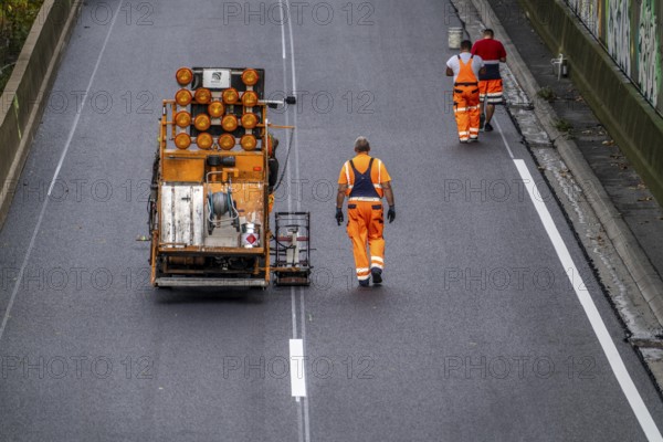 Marking work after the application of new whisper asphalt surface for the A40 motorway, in the