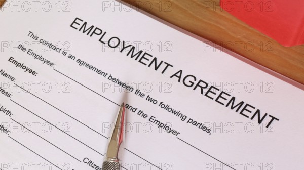 Symbolic image: Blank form of an employment contract on a desk (English)