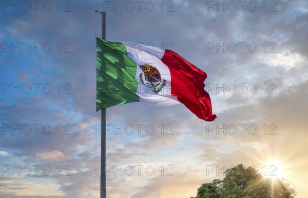 Los Cabos, Mexico, Mexican tricolor national striped flag proudly waving at mast in the air with