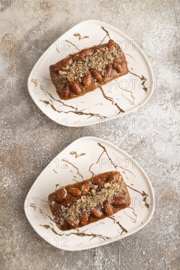 Caramel and almond cake on brown concrete background. top view, flat lay, close up