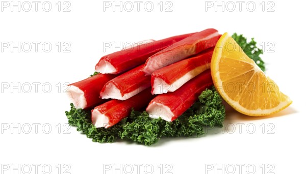 Fresh crab sticks, on Kale leaves, lemon slice, on a white background, horizontal, no people,