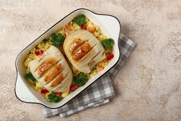 Stuffed squid carcasses, baked in the oven, fried, with couscous, top view, homemade, no people