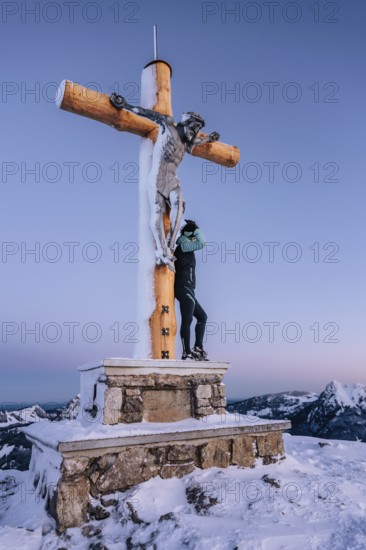 Summit bliss in the snow-covered winter landscape in the Tannheimer Tal in the Alps on the