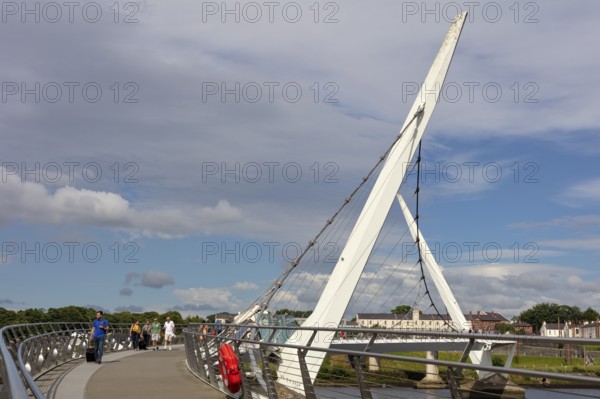Side view of a modern bridge under a clear blue sky, Londonderry
