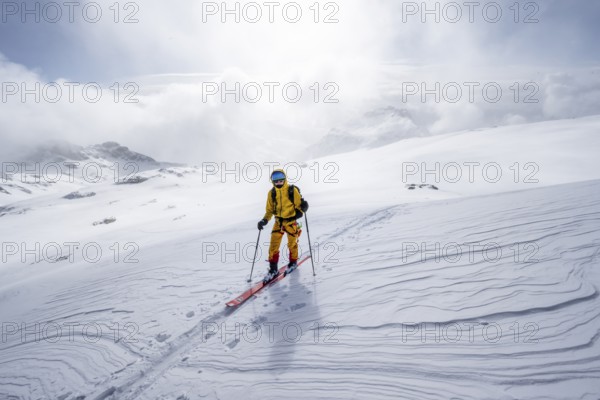 Ski tourers in a snowy mountain landscape, ascent to the Wildhorn, cloudy mood, high tour, Bernese