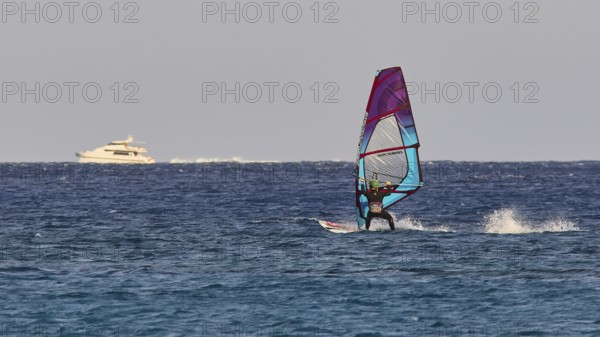 Windsurfer near a yacht in the middle of the blue sea, windsurfer, Meltemi windsurfing spot, Devils