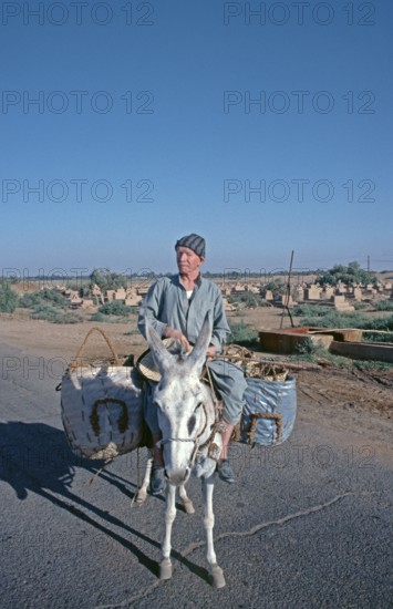 Elderly man on donkey, tourism centre Mut 3, main town El-Qasr of the oasis ad-Dachla, Libyan